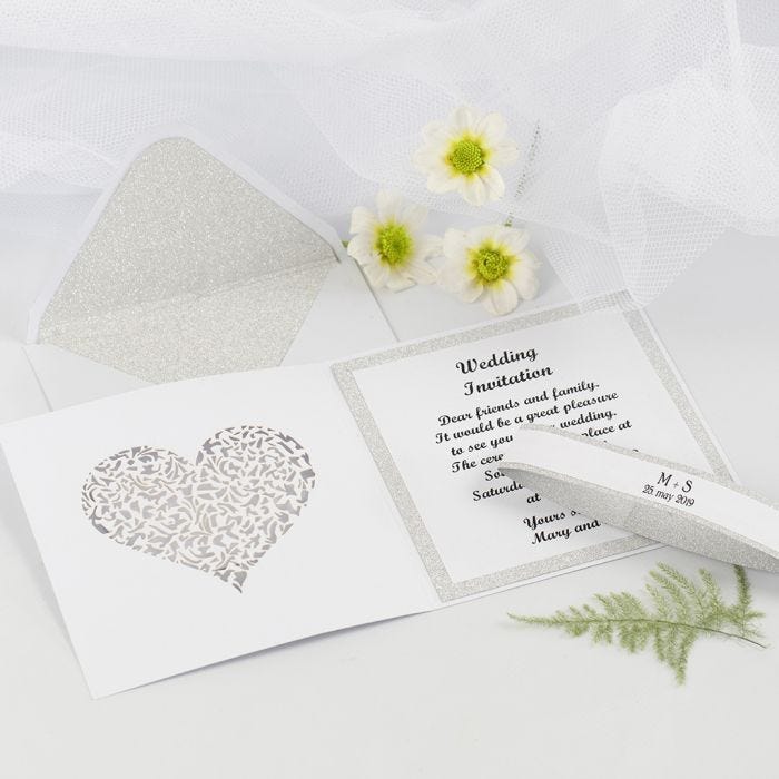 Une invitation de mariage et une enveloppe décorées avec du papier design