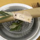 A place card from recycled card  decorated with a skeleton leaf